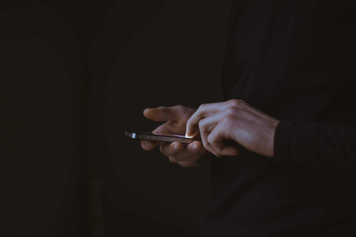 a person's hands holding a phone